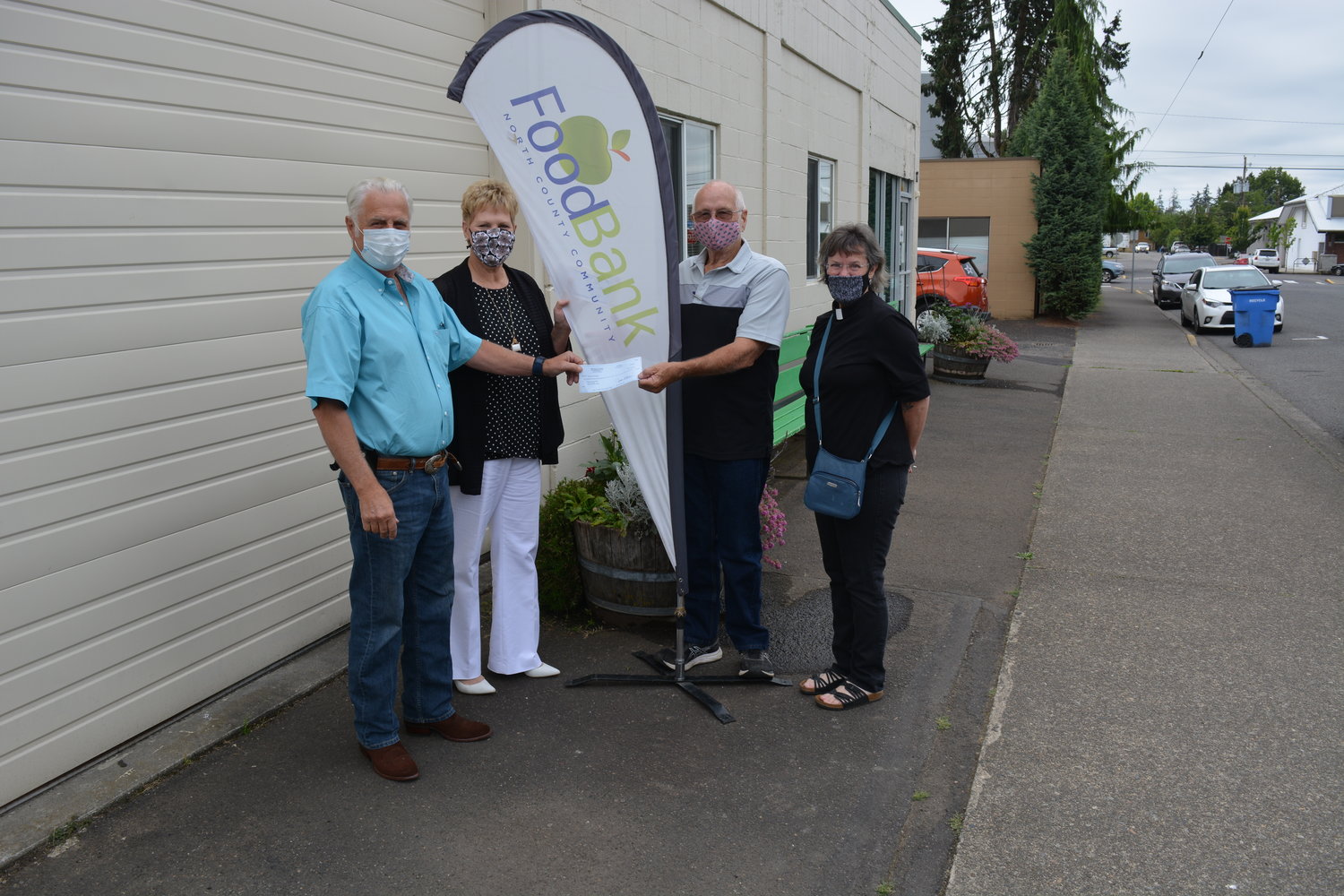 North County Community Food Bank Board Members Jerry Kolke and John Idsinga stand with Executive Director Liz Cerveny (second from left) and United Methodist Member Susan Boegli (right).