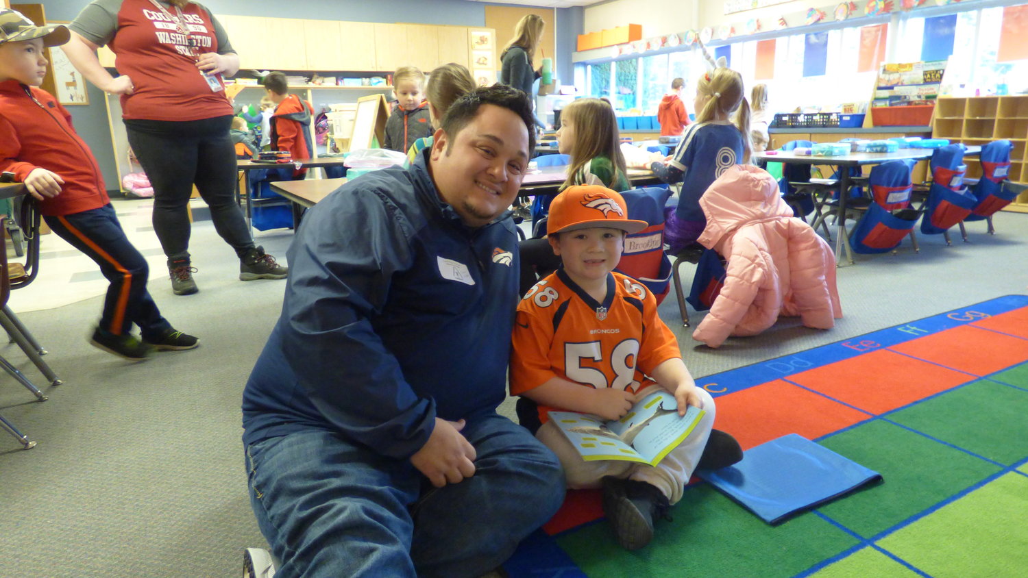 Cooper Miller, a kindergartener at Union Ridge Elementary School, sits with his dad in teacher Josie Bleth's classroom. 