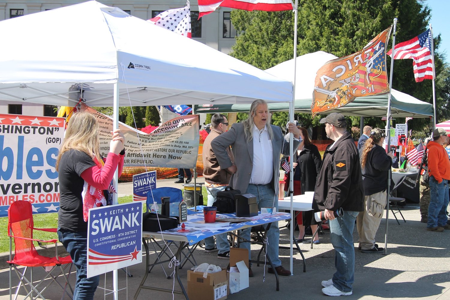 Supporters man the Keith Swank for U.S. Congress booth at the “March for Our Rights” rally in Olympia on April 27.