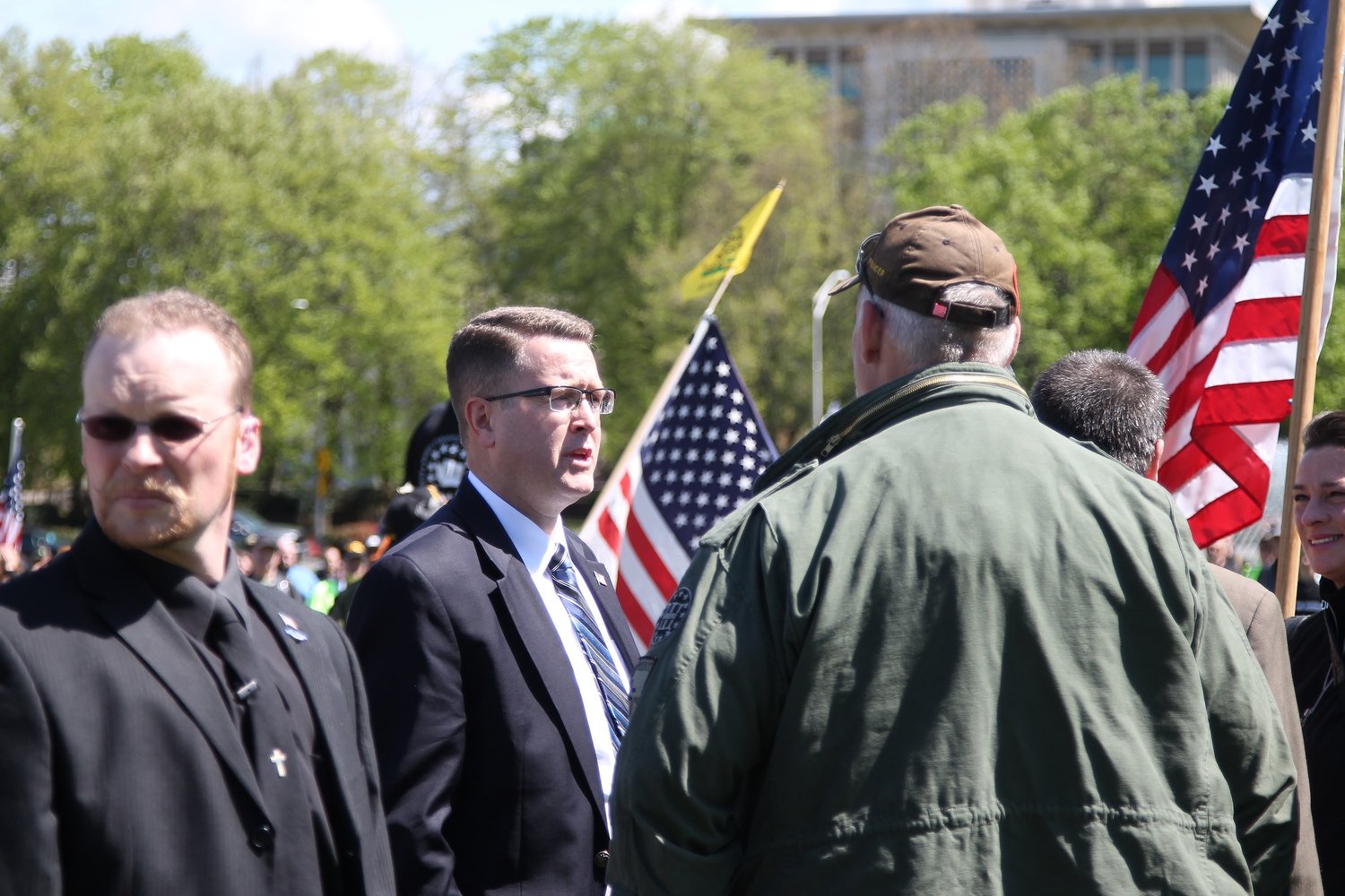 Rep. Matt Shea, R-Spokane Valley, speaks to attendees, while flanked by security guards, at the “March for Our Rights” rally in Olympia on April 27. 