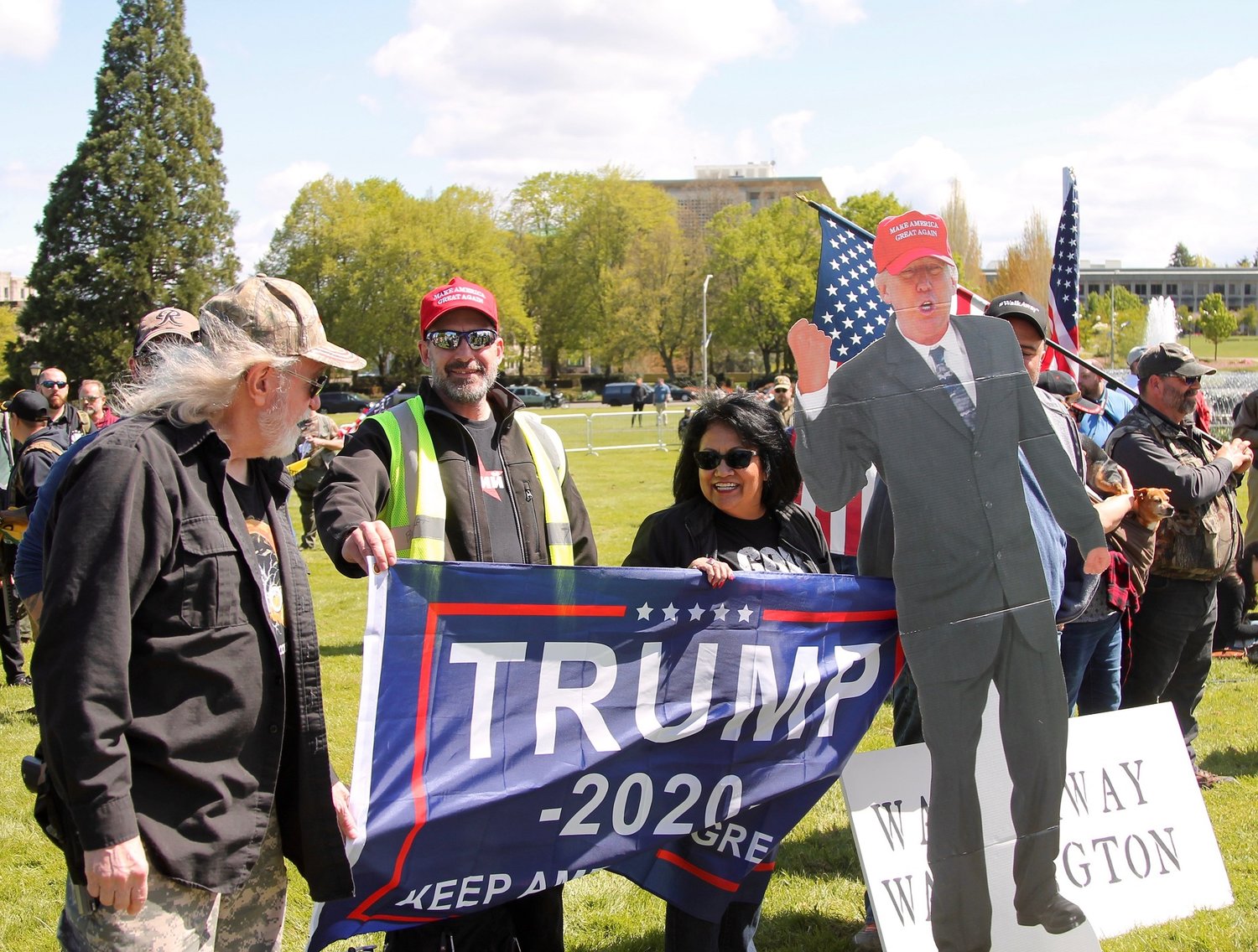 Attendees at the “March for Our Rights” gun rally hold a President Donald Trump cardboard cutout and Trump 2020 Flag.