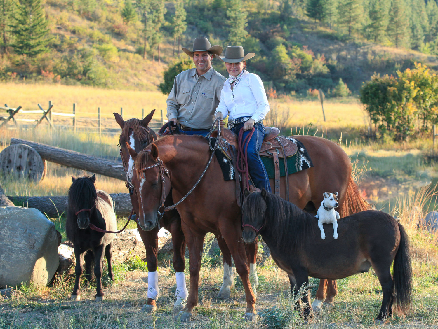 Steve Rother and Francesca Carsen of Rother’s Horsemanship in Eastern Washington sit atop two full-size horses while flanked by mini horses Jet (left) and Spanky (right). Atop Spanky sits Dally, a Jack Russell.