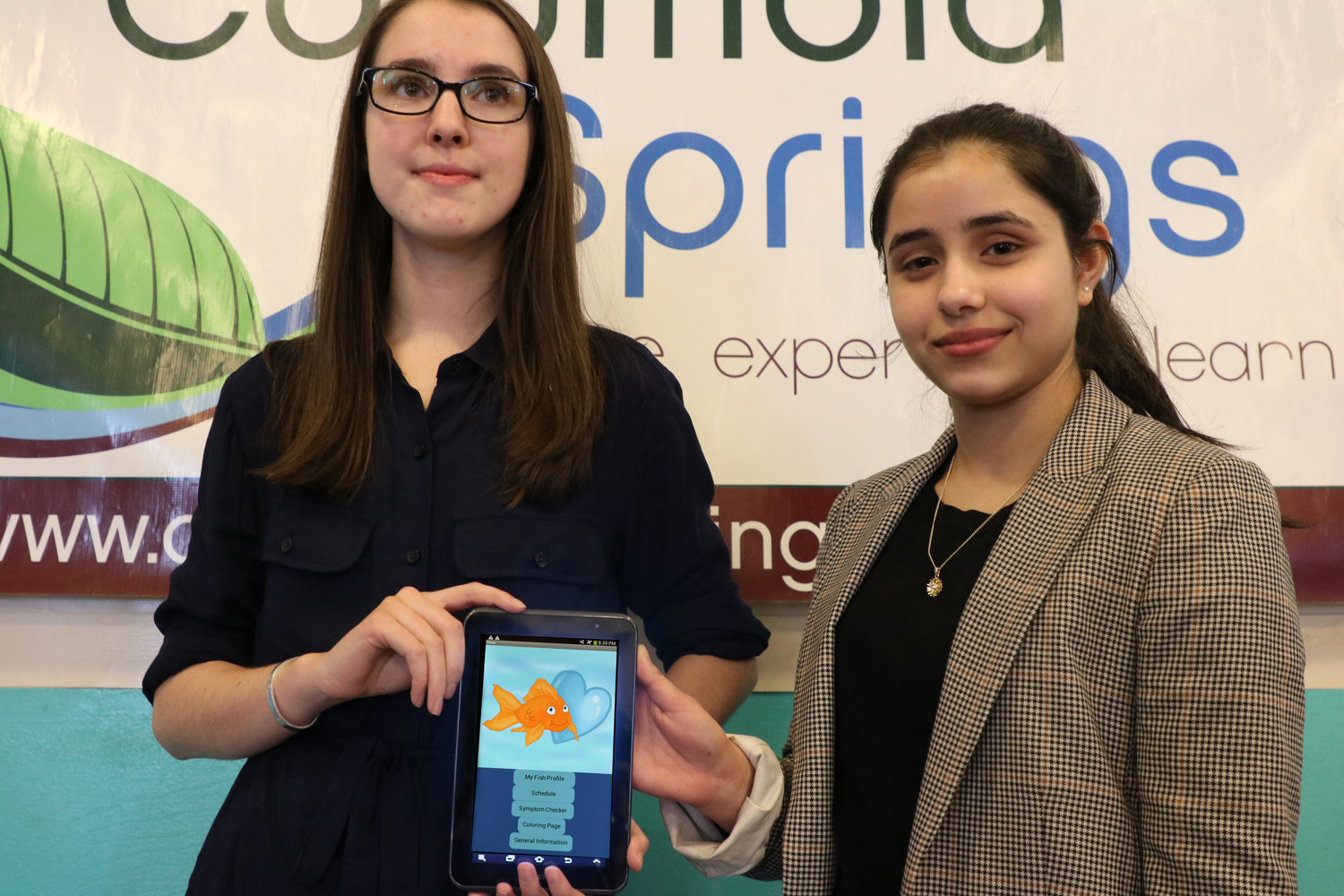 Skyview High School seniors Annika Epperly (right) and Ojasvi Kamboj (left) proudly present their app “Fin-damentals of Fish Care” at Columbia Springs when they won the 2018 Congressional App Challenge Feb. 20th.  