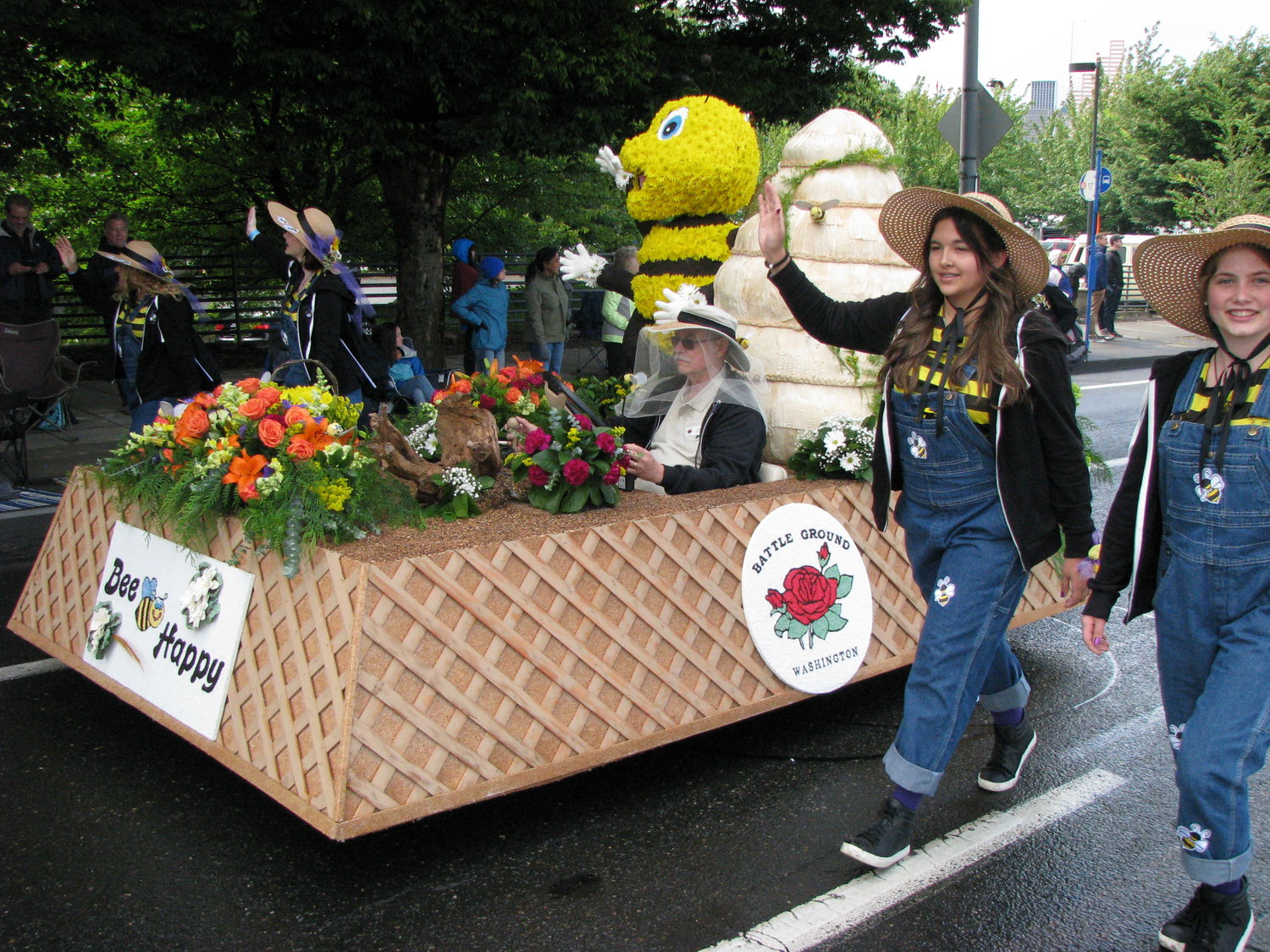 A Battle Ground Rose Float, built entirely by volunteers, participated in the Portland Grand Floral Parade June 9. Walking with the “mini” float through the 4.3 mile parade route were princesses, from left, Pamela Lopez, Rebecca Strizver, Kiana Skinner and Sarah Vonk. Darrell McClellan is the driver.