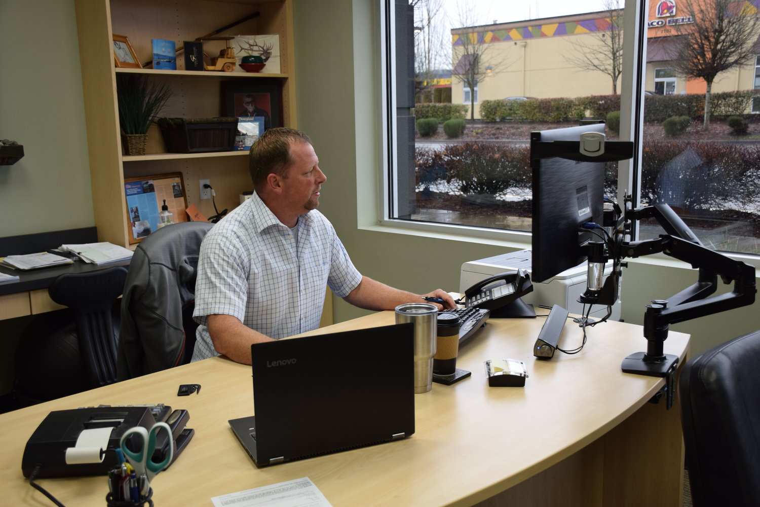 Elite Collision Center President Kevin Morse works at his office. Fifteen years into the business he says they were in a good place both geographically with Battle Ground’s mix of urban and rural and with a business formula that has made them successful.