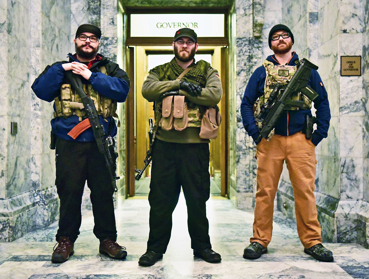 Gun-carrying friends, left to right, Jake Garza, 26, from Graham, Ian Stobie, 30, from Puyallup, and Ben Garrison, 30, from Puyallup, stopped to pose outside the governor's office Jan.12 following the Gun Rights Coalition's Rally 4 UR Rights at the state Capitol in Olympia.