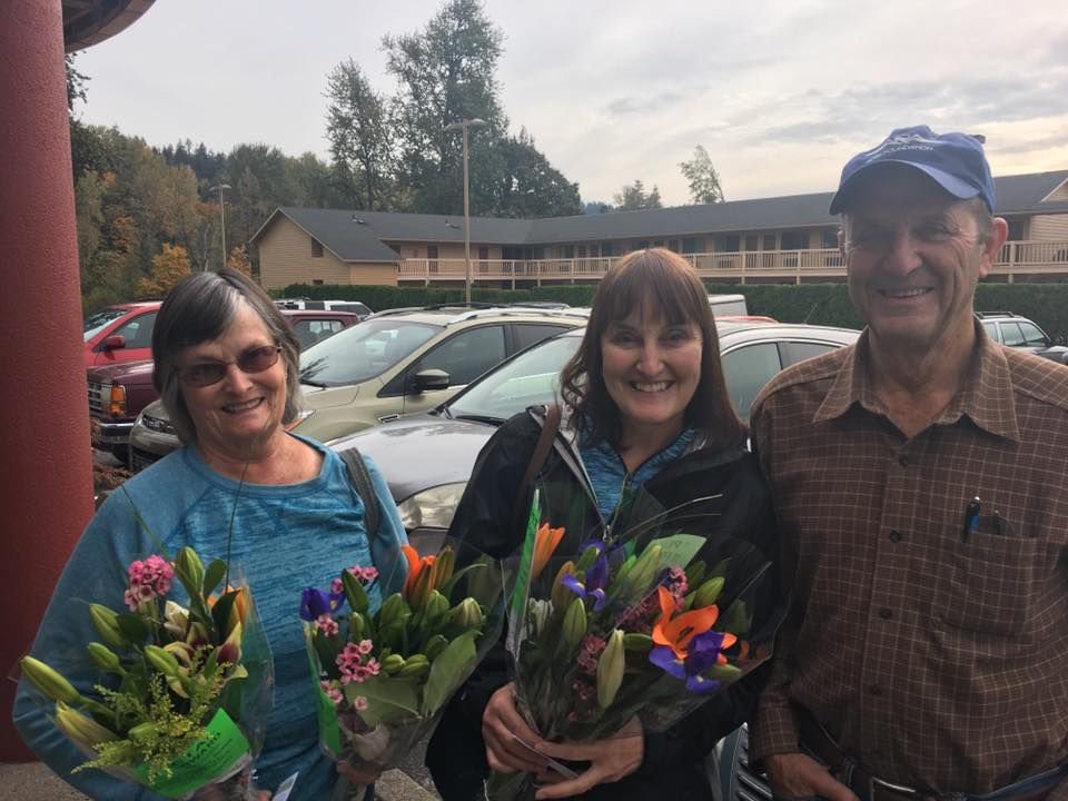 Happy recipients of flowers stand outside of Burgerville in Woodland during “Petal It Forward” in 2016. Holland America Flower Gardens will be taking part in the event again, passing out 200 pairs of bouquets with one for a recipient to keep and another to give.