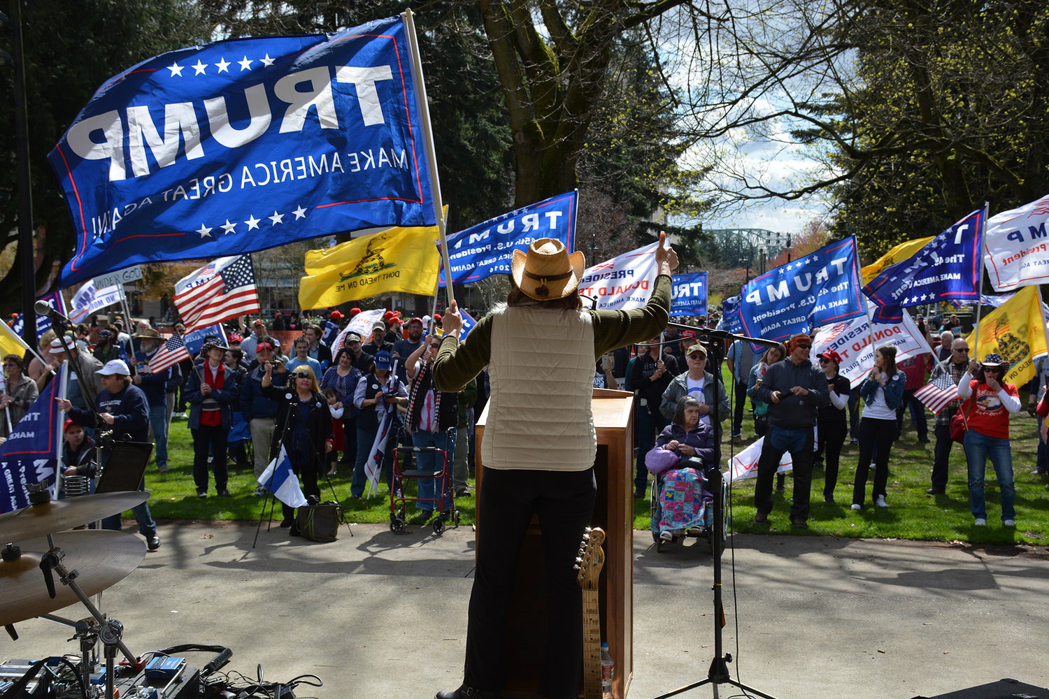 State Rep. Liz Pike, R-Camas, waves a Trump flag and addresses the crowd at the "Rally for Trump and Freedom" last Sunday in Vancouver. 