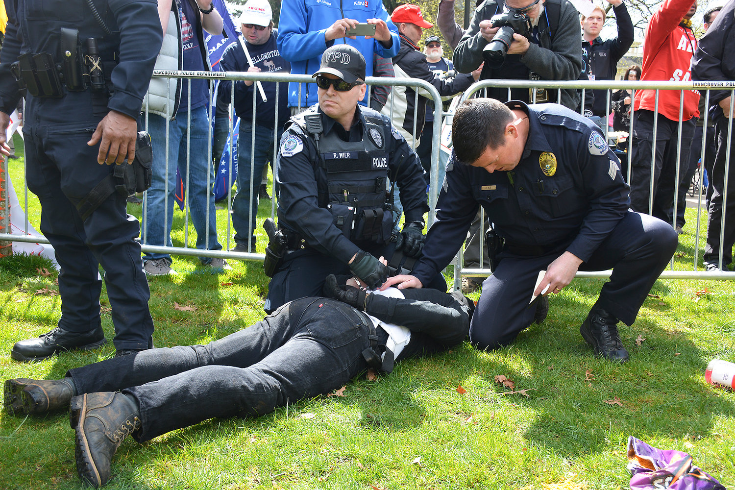 Anarchists are arrested Sunday during a pro-Trump rally in Vancouver after attempting to break through a small plastic fence separating them from the Trump supporters. 