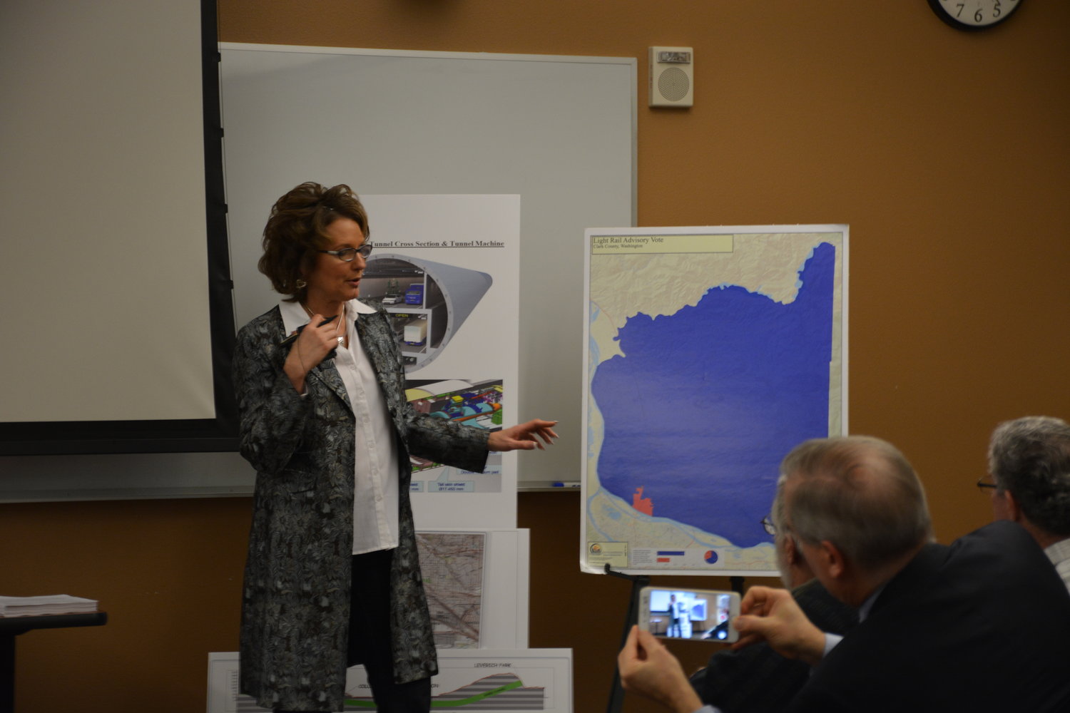 Washington state Rep. Liz Pike, R-Camas, points at a visual showing voting on a light rail (dark area meaning voting against light rail) during a “Transportation Solutions” town hall on Feb. 11.
