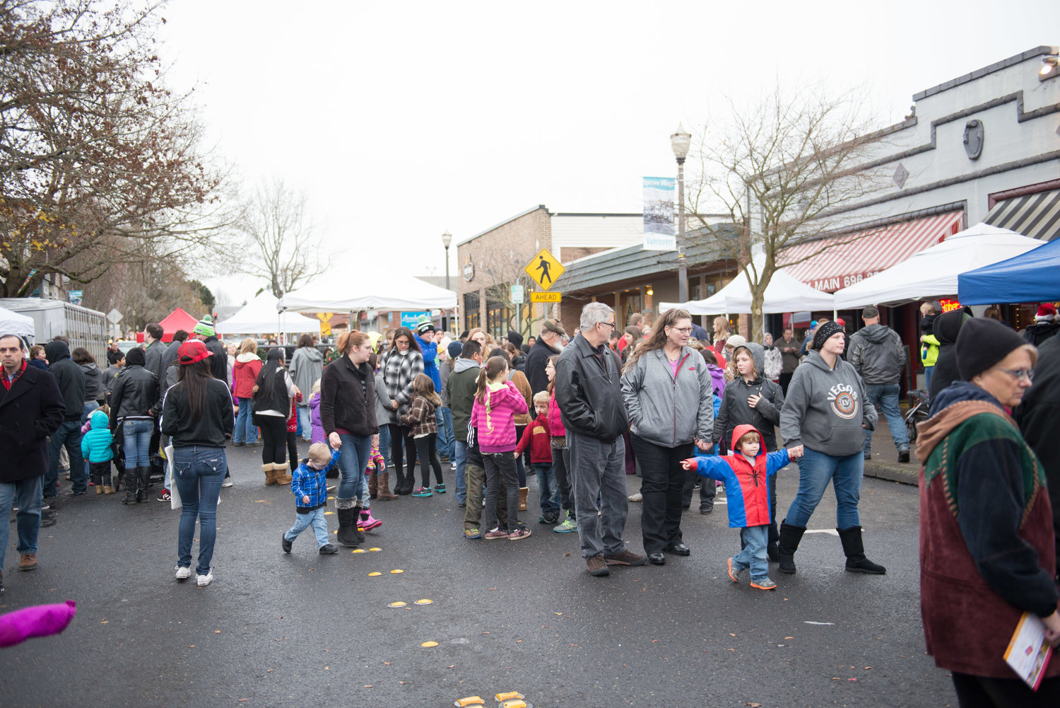 Attendees meander in the closed-off section of Main Street during the 2015 live reindeer Christmas block party at Vancouver’s Uptown Village.
