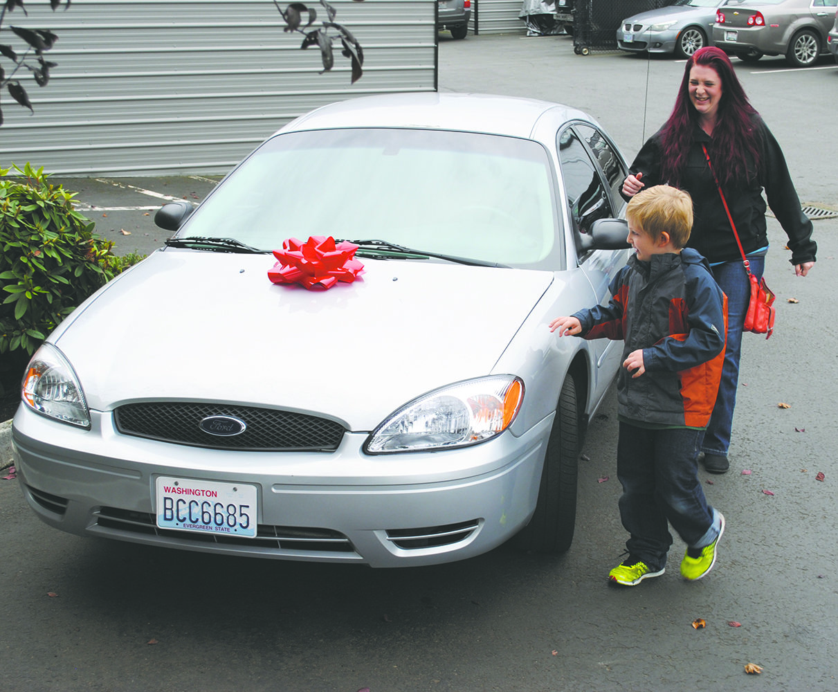Celia Wilbur and her son Connor, 6, react to their new car. Elite Collision &amp; Auto Spa partnered with Chappelle’s Towing to kickoff Uplift, where they donated a car to a member of the community. 