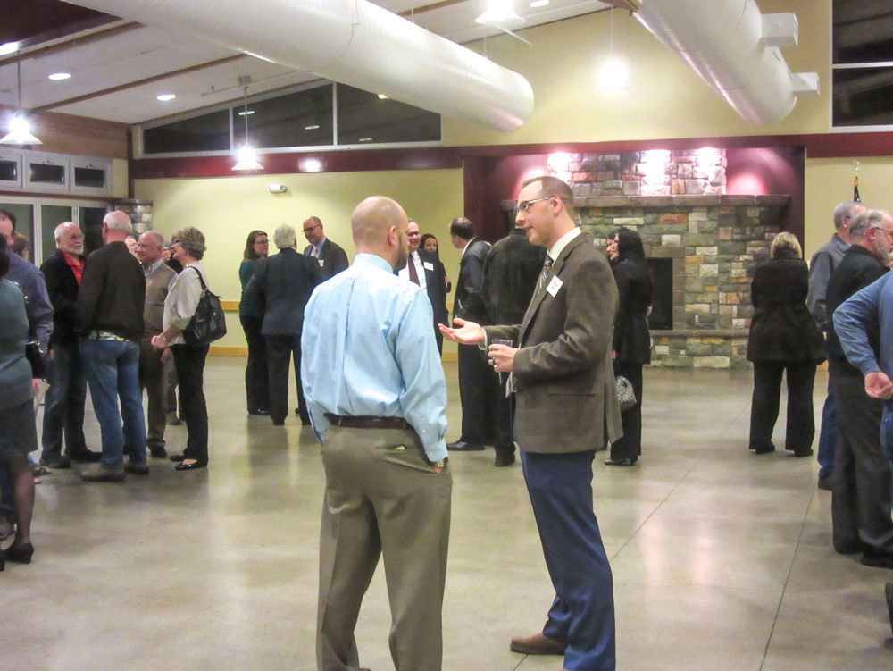 ONE OF THE SIX finalists for the position of Battle Ground city manager, Matthew Brown, talks with Council Member Lyle Lamb during a March 3 Open House event at the Battle Ground Community Center.