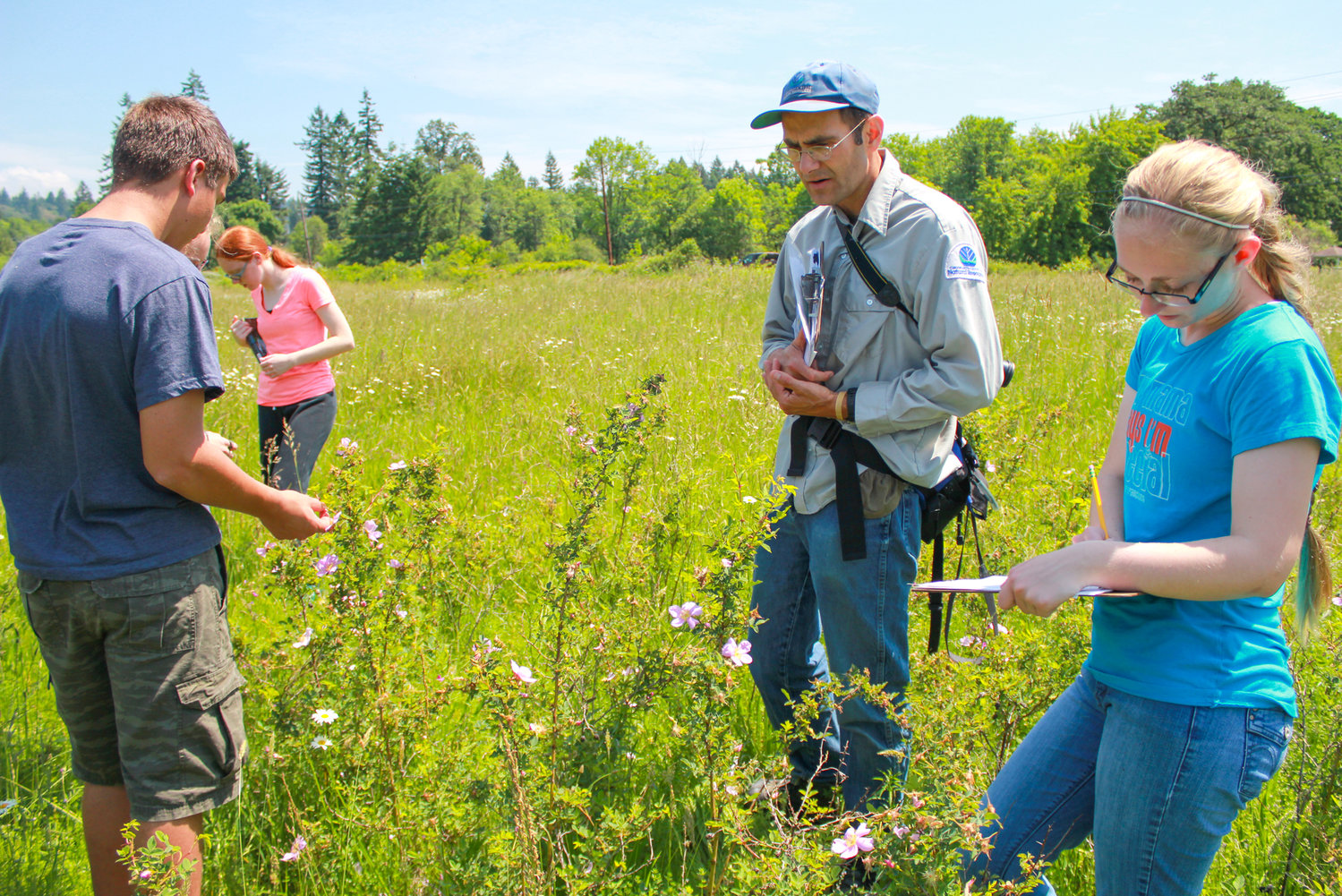 CASEE STUDENTS are shown here recording the number and types of pollinators that use the flowers in the Lacamas Prairie Natural Area. CASEE is one of the Battle Ground School District’s Career and Technical Education (CTE) programs. 