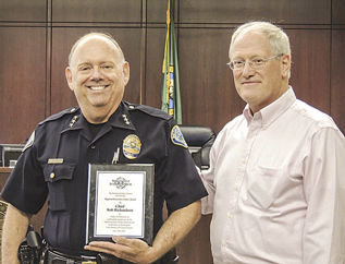 BATTLE GROUND POLICE CHIEF Bob Richardson is shown here receiving an award from the Northwest Justice Forum. The award was the 2015 Regional Restorative Justice Award and was presented to Richardson by Eric Gilman (right), Clark County Juvenile Court.