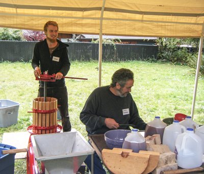 FRIENDLY HAVEN RISE FARM’S Joseph Freeman (seated) and Noah Seely (back left) prepare to press cider at a past Heirloom Apple Tasting &amp; Old Apple Tree ID event.