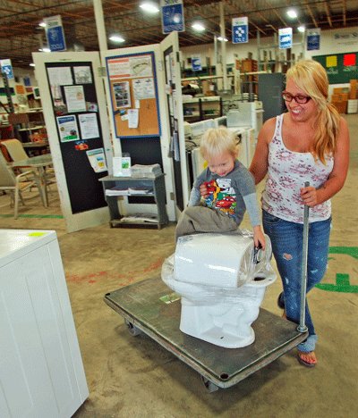 SHOPPERS KIM Peragine and son Geo, 2, leave the store with what Geo describes as “my new toilet.” Photo courtesy of FH Browne