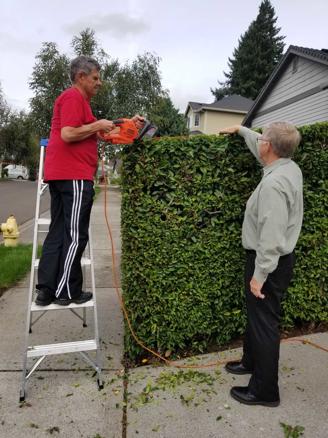A Villages Clark County volunteer trims a hedge for a member. The non-profit membership organization connects seniors with volunteers who can help with day-to-day tasks.