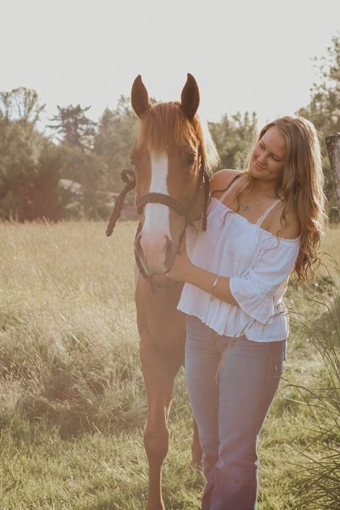 Hannah Spicer, of the graduating class of 2020, poses with her horse, Lacy, for her senior portraits last year.