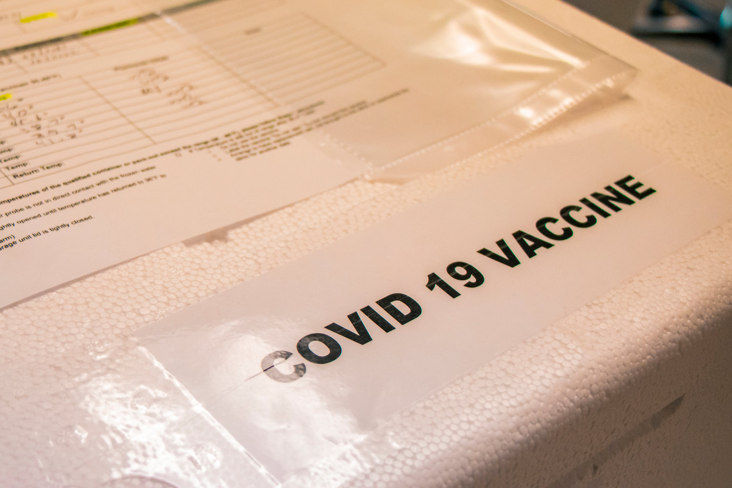 A cooler containing the Pfizer COVID-19 vaccine sits on a table at Prestige Post-Acute and Rehab Center Jan. 14 in Centralia.