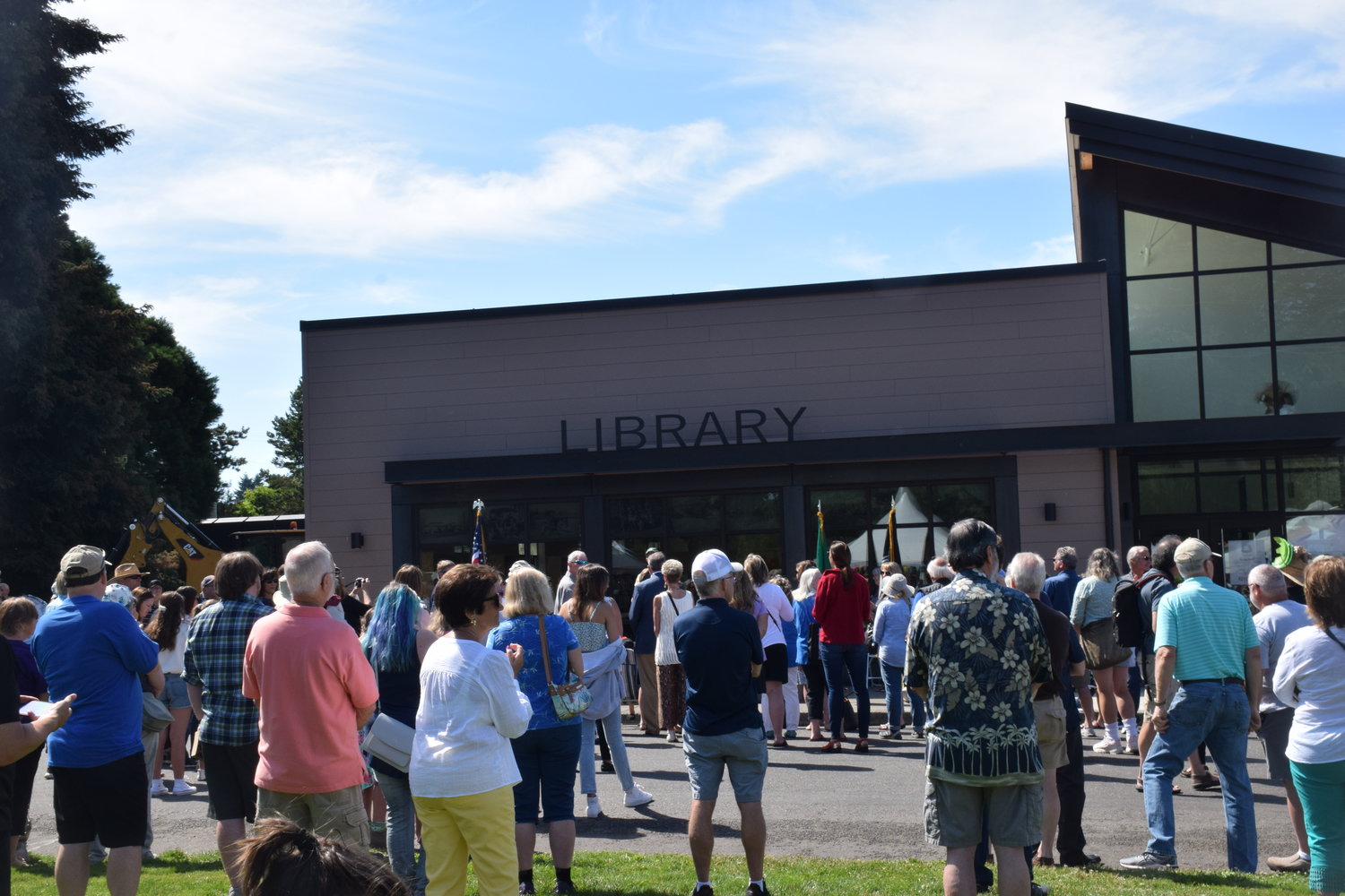 A crowd gathers to hear speakers before a ceremonial ribbon cutting during the grand opening of the Ridgefield Community Library on July 9.
