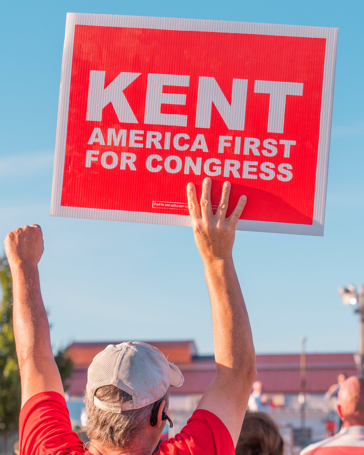 A Joe Kent supporter holds a sign at a rally in Clark County Monday.