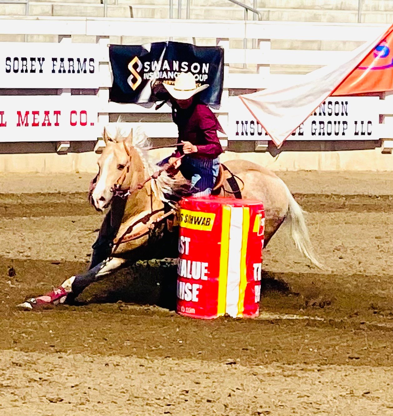 Hailey is shown racing around a barrel with her horse Grizz.