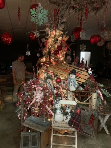 A red tree made up of different household Christmas items is pictured.