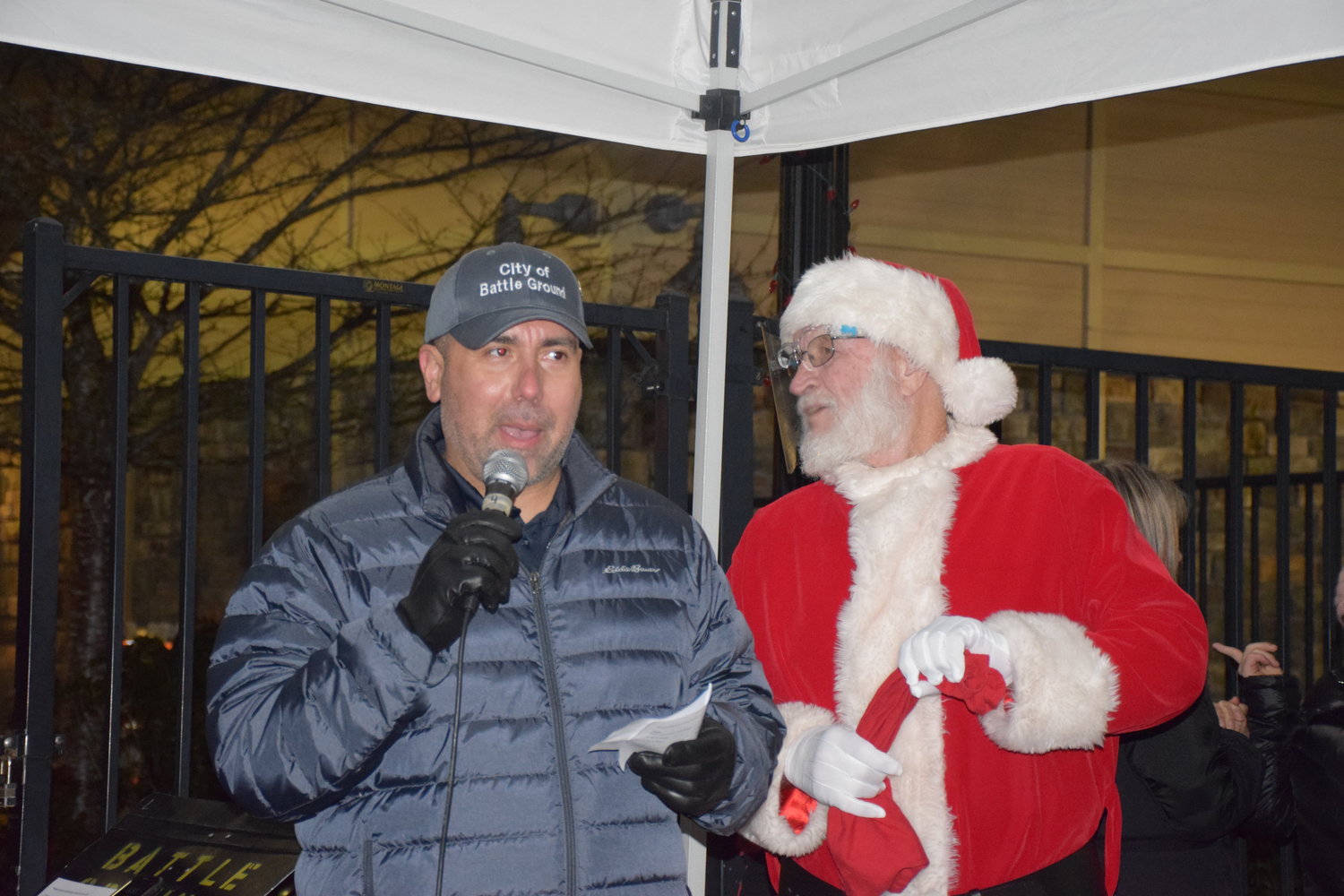 Battle Ground Mayor Adrian Cortes speaks with Santa at his side during the city’s annual tree lighting ceremony on Dec. 3.