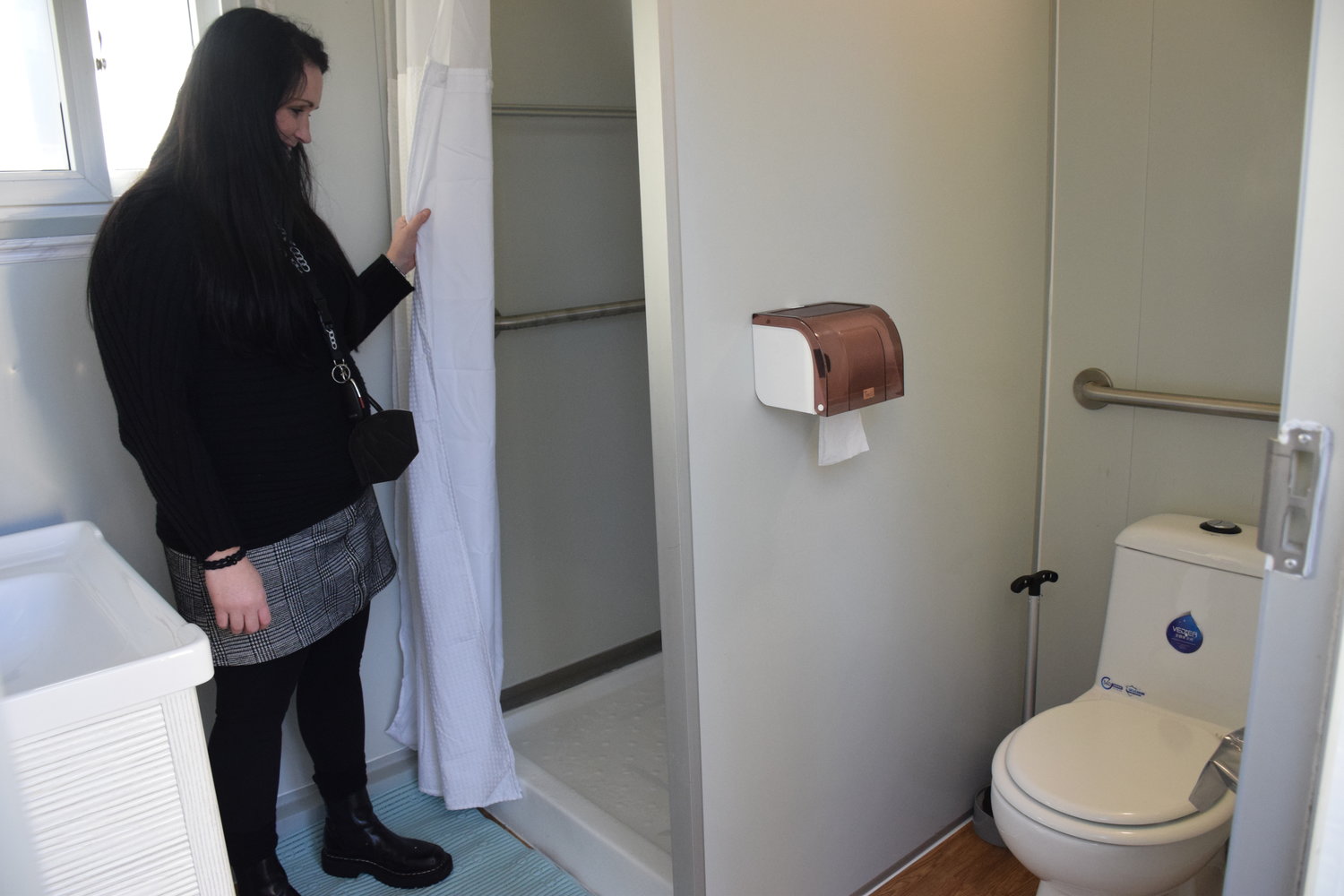 Battle Ground Deputy Mayor Cherish DesRochers speaks about the amenities located in a “shower pod” installed at Immanuel Lutheran Church in Vancouver.