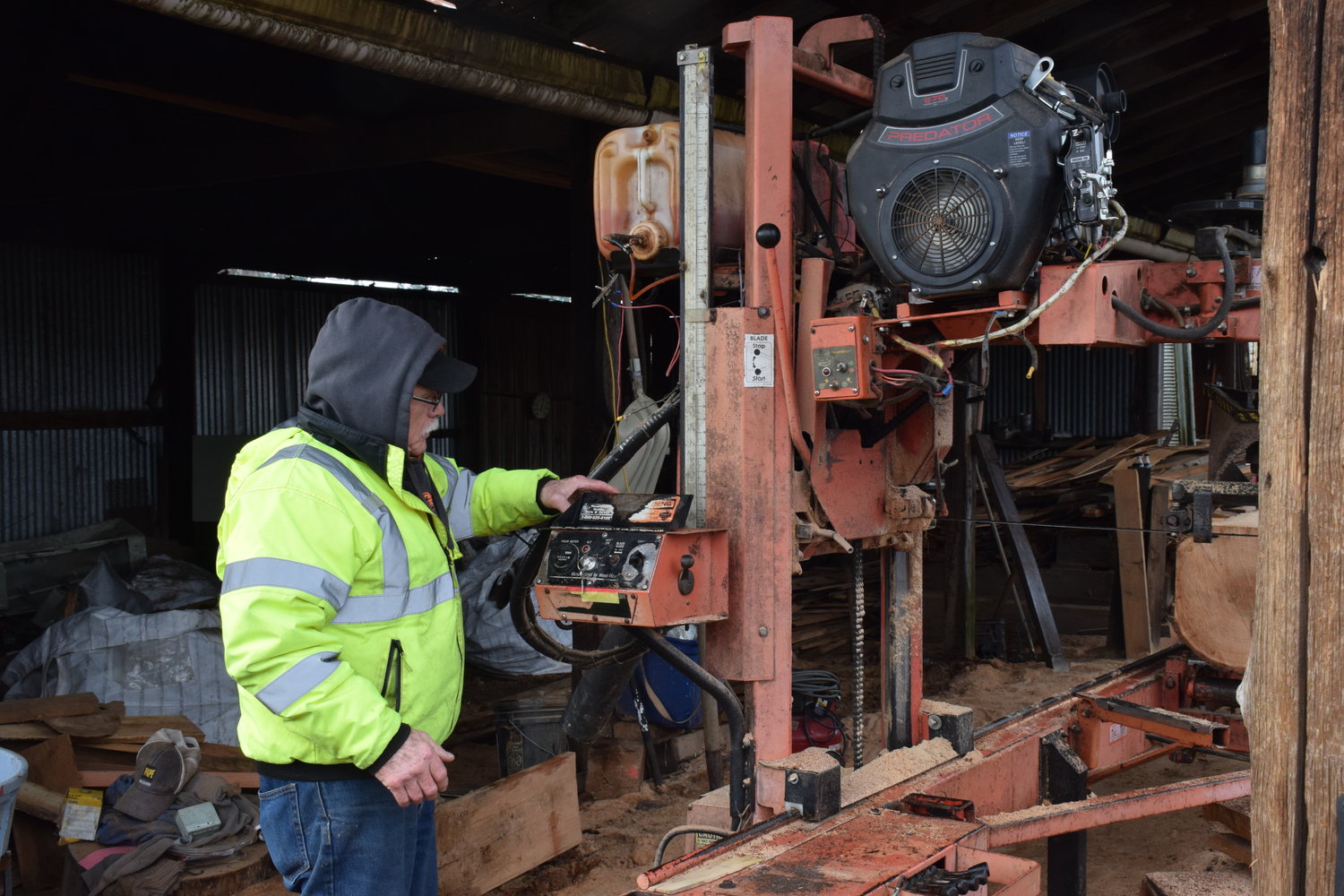 Dollar’s Corner Sawmill operator Pat Lydon looks at a “Saw-Mizer” sawmill at the location on Feb. 4.