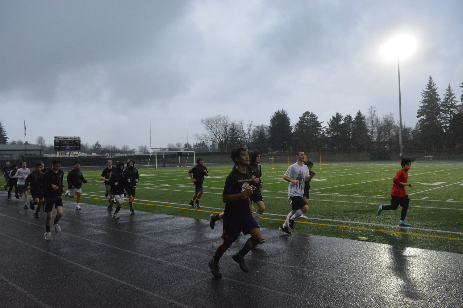 Athletes trying out for the Tigers soccer team jog in the rain on March 2.