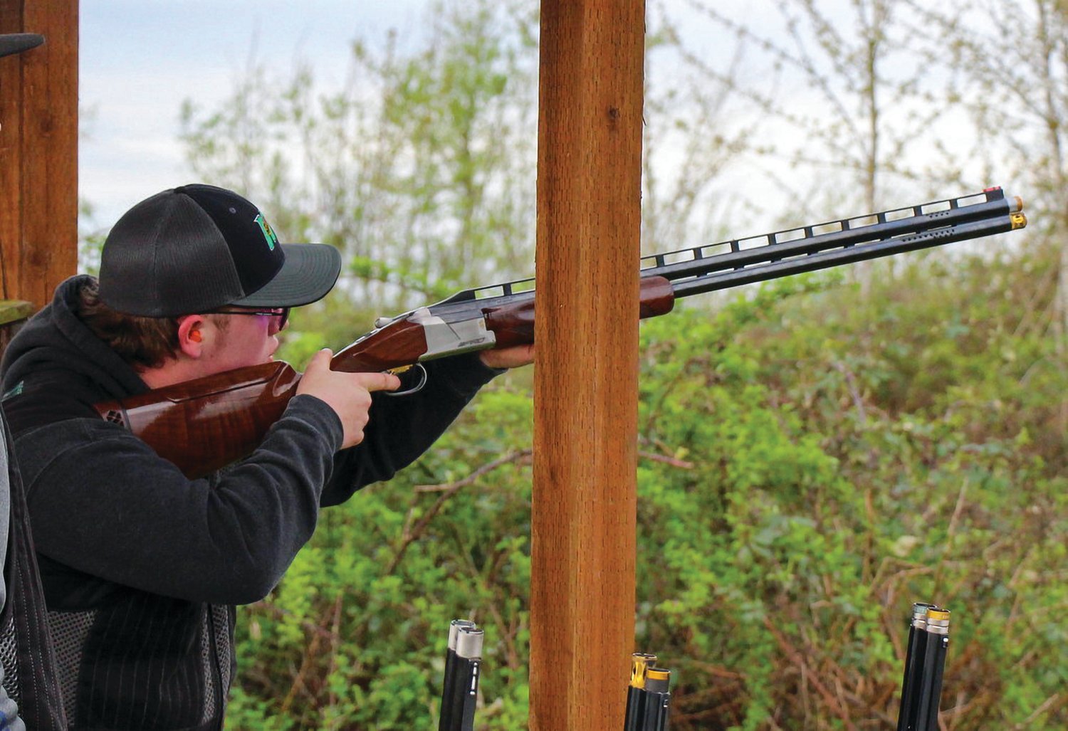 Dane Hauge shoots an over-under shotgun at a range.