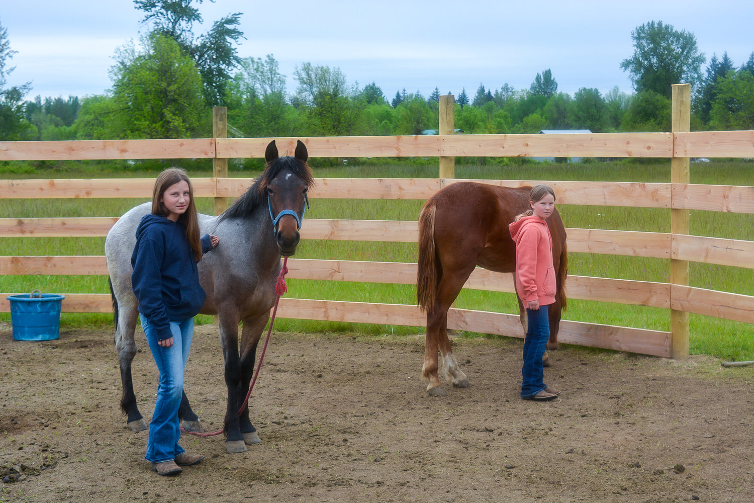 Norah Garlington and her horse Baileymay, left, and Claire Garlington with her horse Albin, right, are pictured at the stable at their home in Battle Ground on May 24.