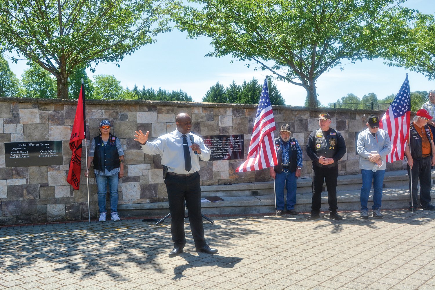 Vancouver Police Department Cpl. Rey Reynolds sings “God Bless the USA” at the Never to be Forgotten ceremony on May 31.
