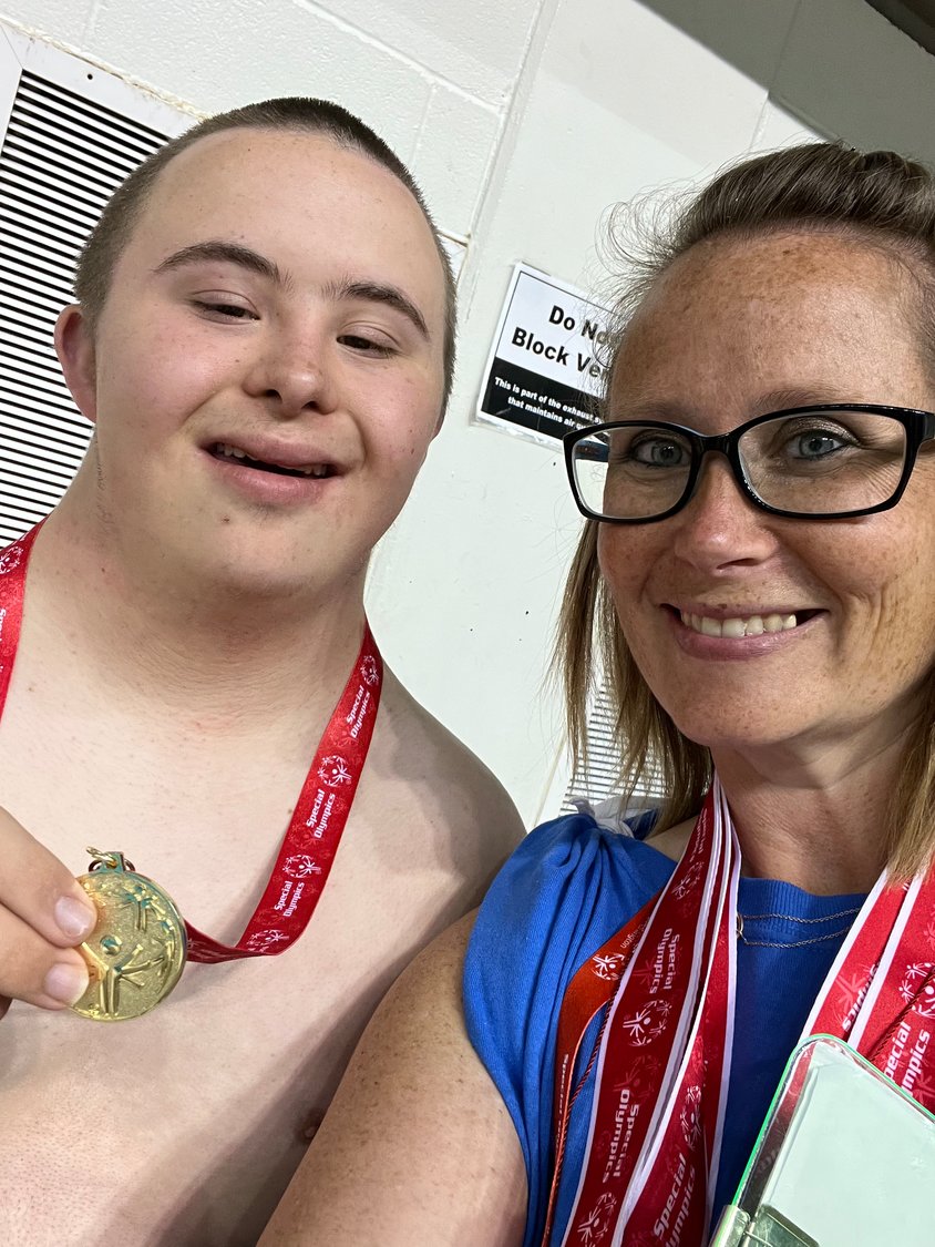 Hezekiah Hewes, and his mother Chandra, smile after he won a gold medal at the state unified Special Olympics swimming competition on June 19.