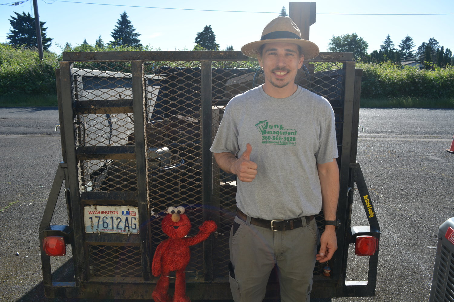 Dan Cain stands behind his Junk Management truck, which contains bricks and wood he acquired from a jobsite on June 22.