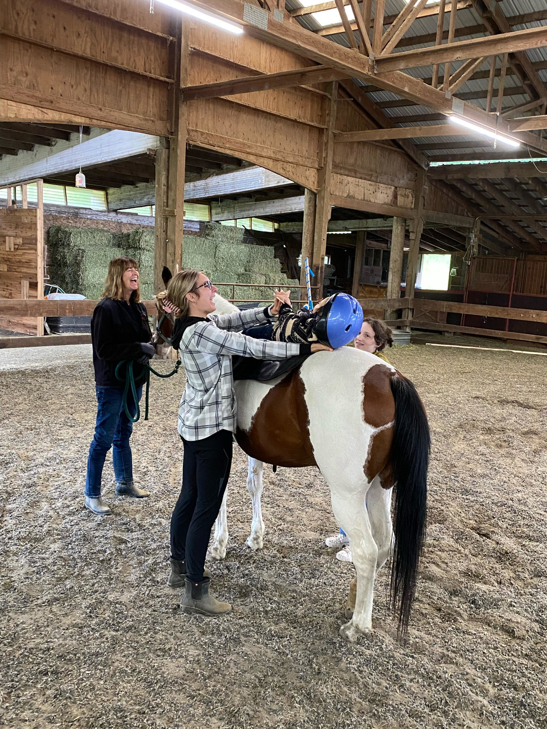 Staff at Healing Steps assist a girl on a horse at their practice in Battle Ground.