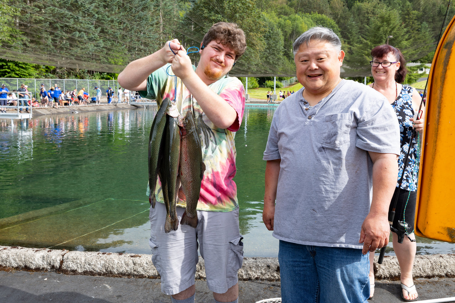 Anglers at the Merwin Special Kids Day in Woodland show off their catch on July 9 in Woodland.