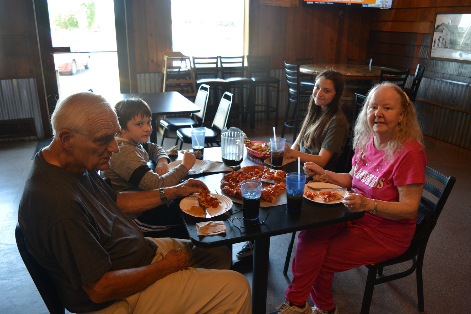 A family enjoys a pizza at Rocky’s Pizza & R Bar in Battle Ground on July 28.