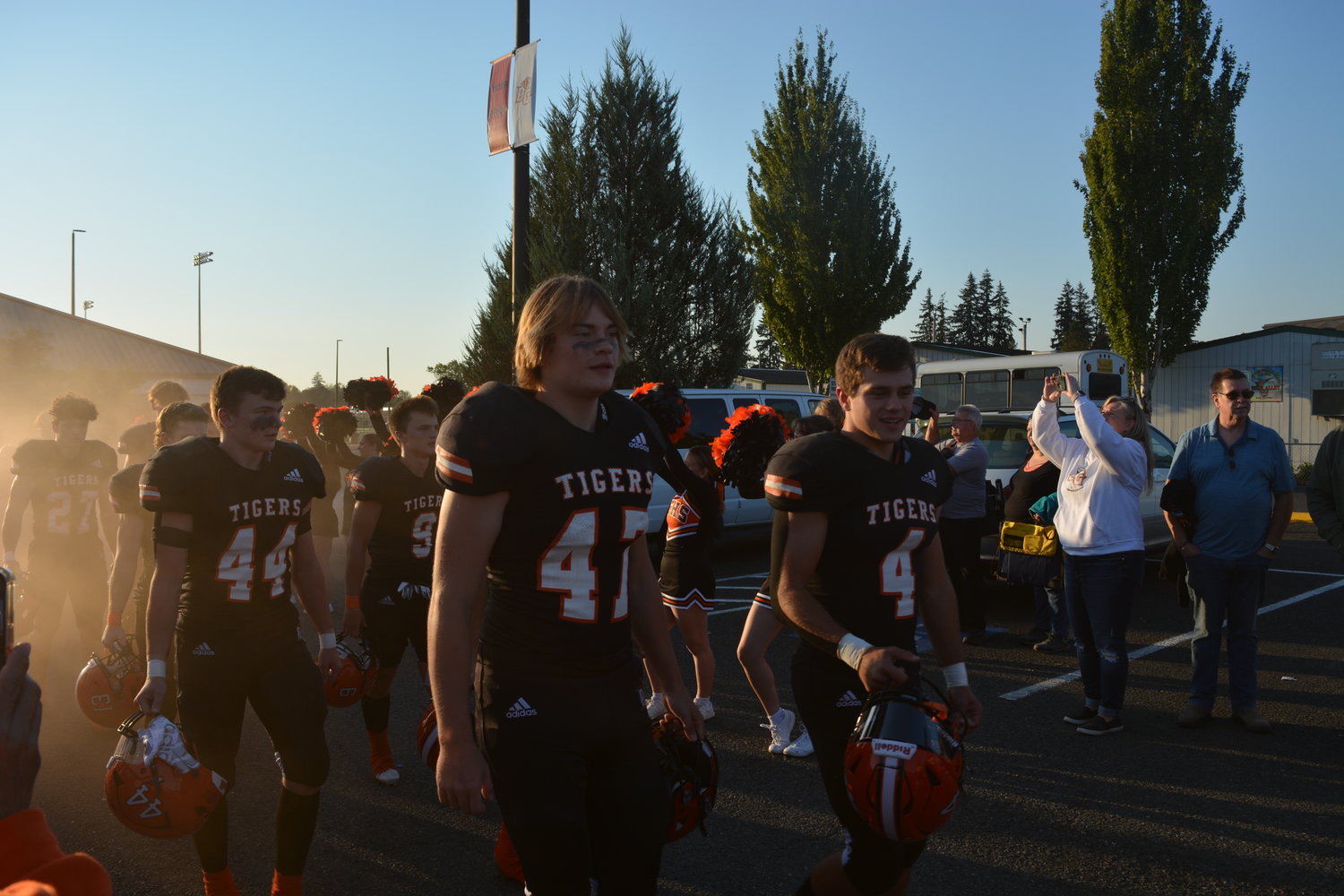 The Battle Ground Tigers walk through the crowd at a celebration marking 100 years of football at the high school on Sept. 30.
