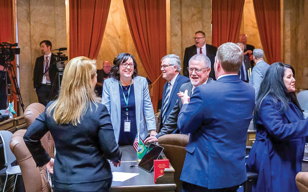 Washington State Rep. Stephanie McClintock, R-Vancouver, talks with legislative colleagues on the House floor.
