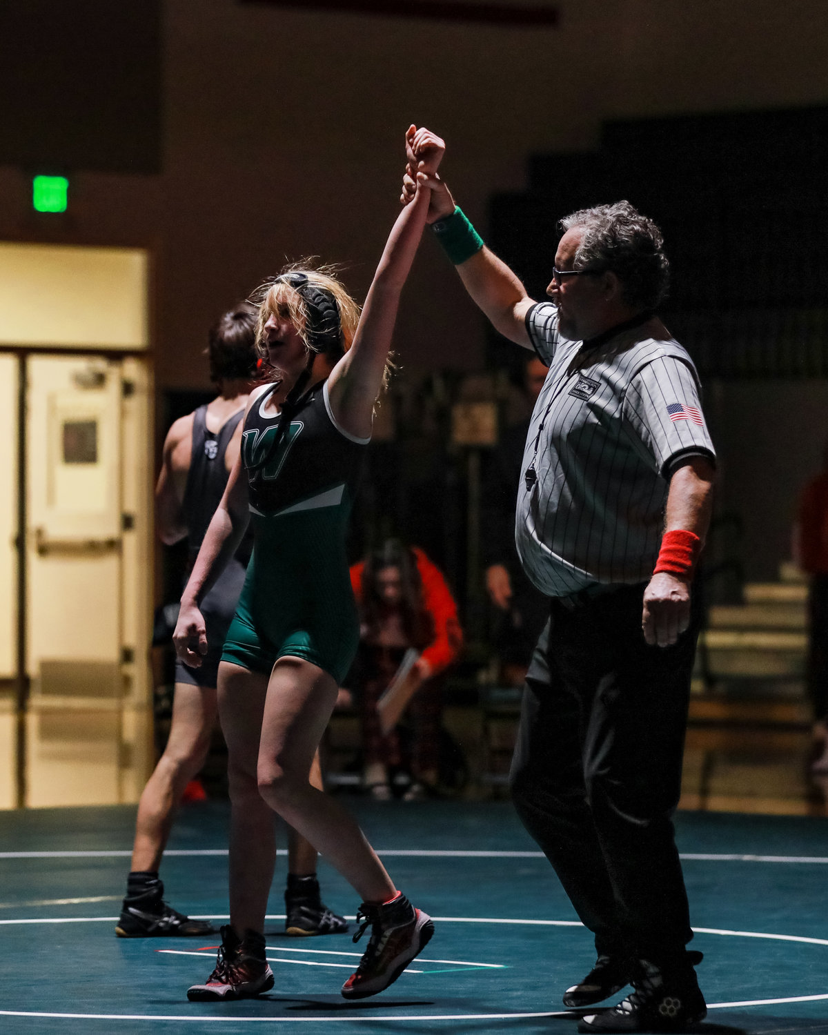Jersey O’Neill, a sophomore at Woodland High School, secures her second victory of the night in the boys’ 106-pound weight class during a home meet on Wednesday, Jan. 11.