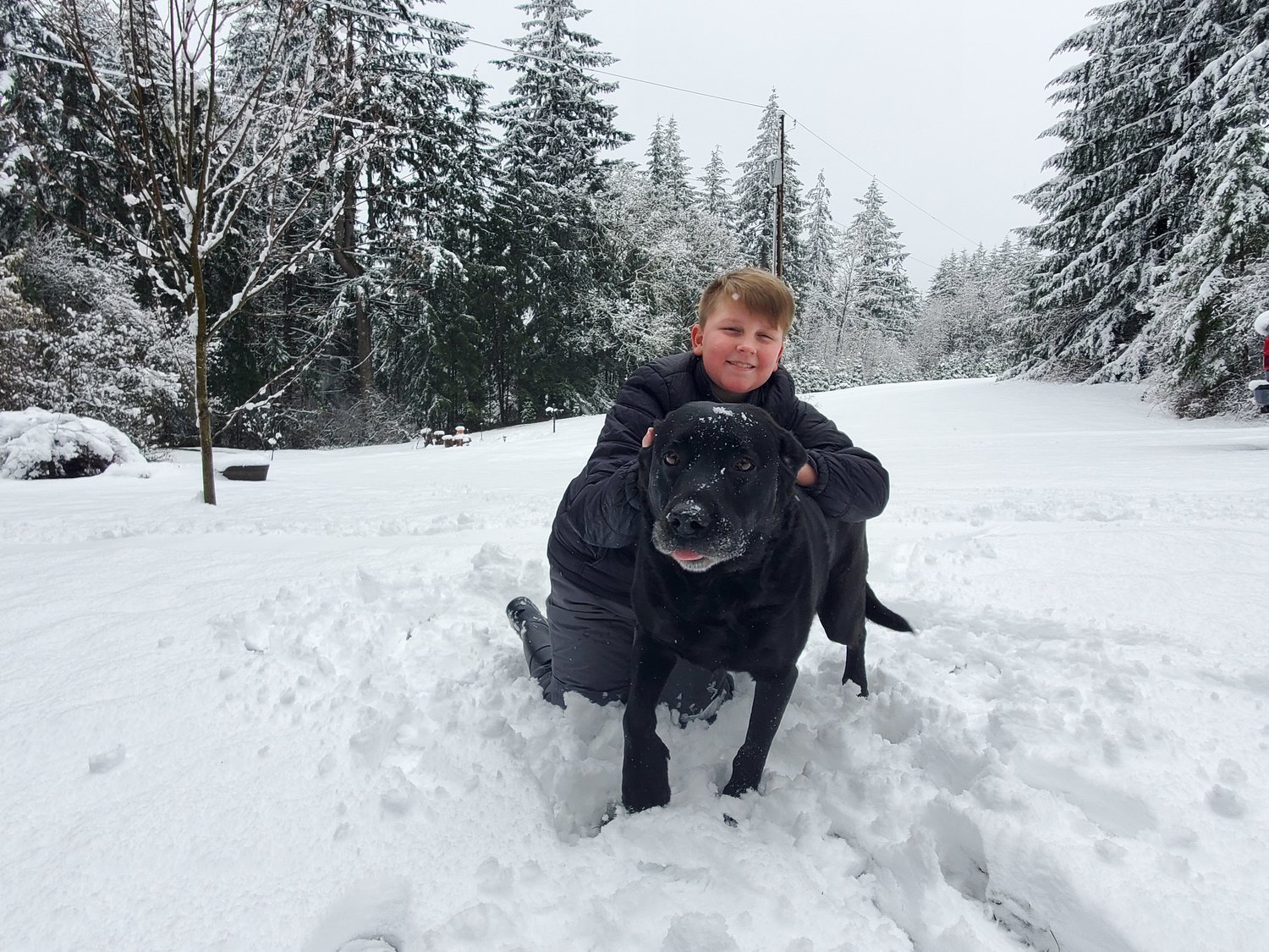 Trew Cross and his dog Diesel enjoy the snow in Battle Ground in this picture taken by his mom Jocelyn Cross.