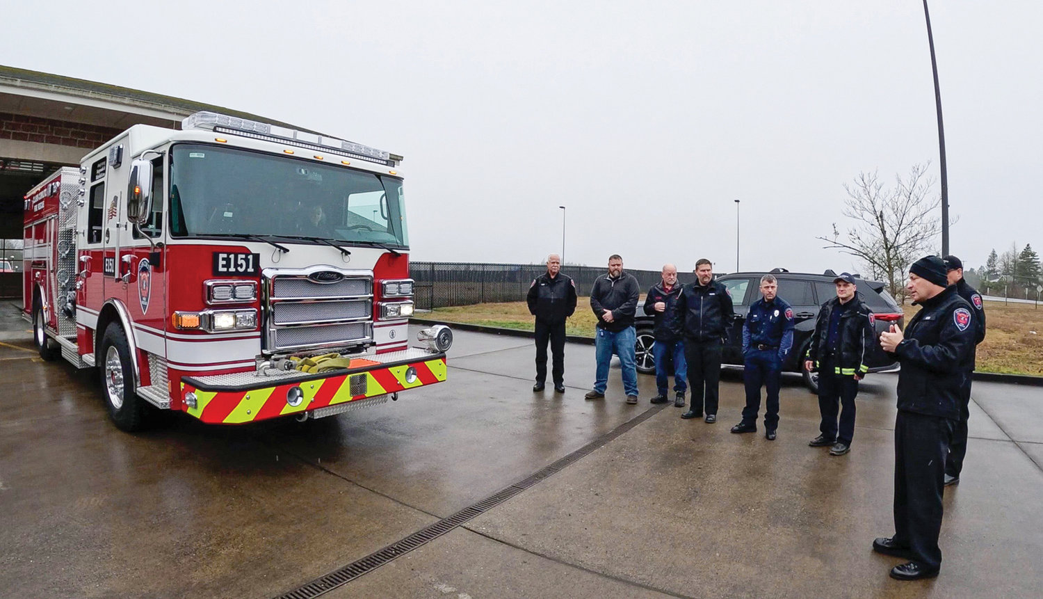 Clark-Cowlitz Fire Rescue Chief John Nohr, right, speaks to firefighters and fire commissioners prior to a “push-in” ceremony for a new fire engine at Station 151 on March 8.