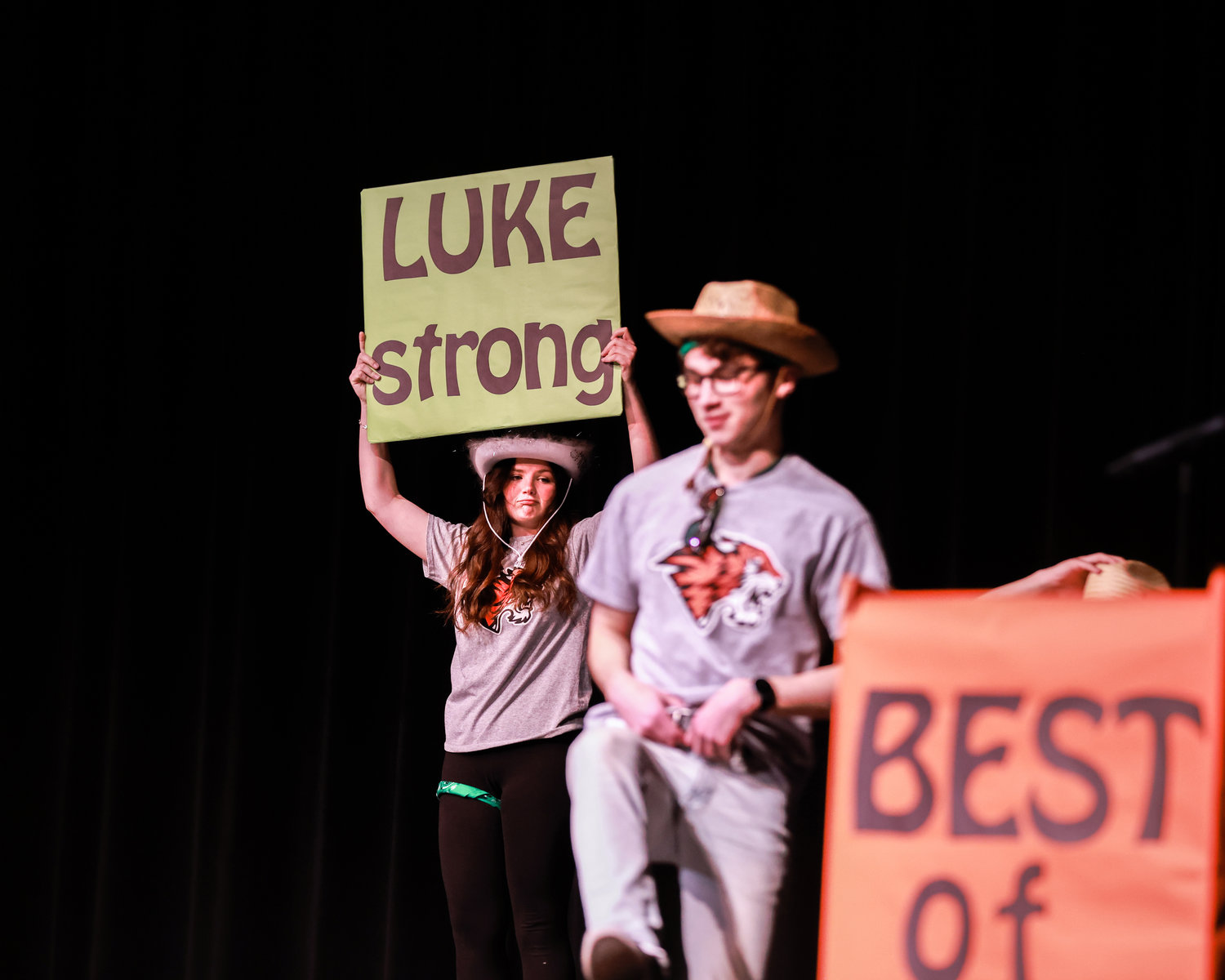 Morgan Nixon holds a "Luke Strong" sign during the opening dance of the Best of BG competition on Saturday, March 25 at Battle Ground High School.  The event raised money for Luke Montei, a teen who received a heart transplant the following day.