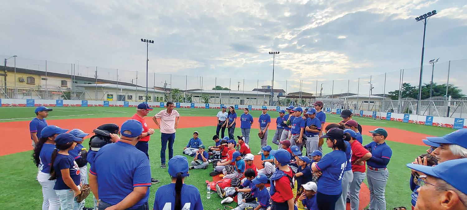 Don Freeman speaks to a group of young baseball and softball players in Ecuador earlier this year.