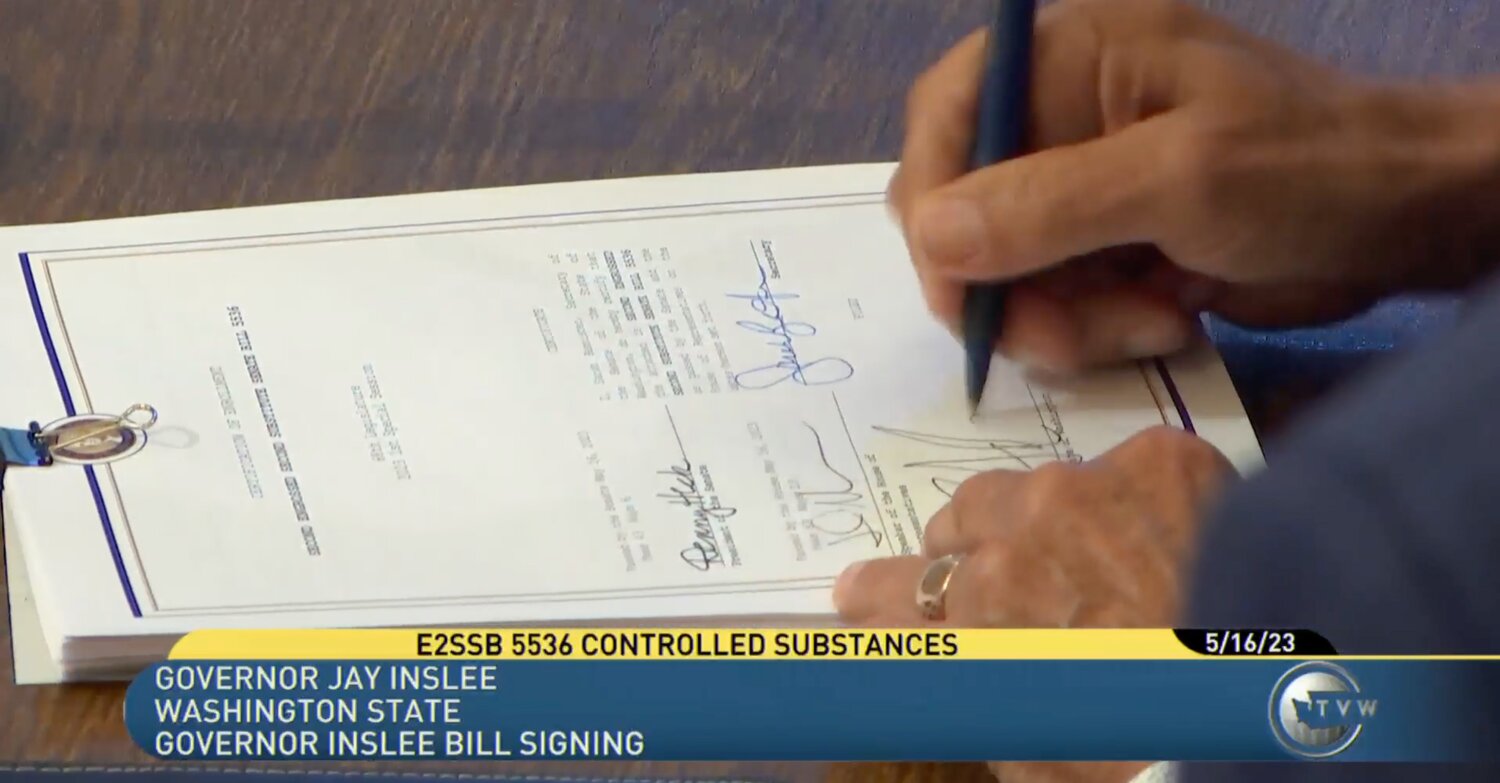 Gov. Jay Inslee signs Senate Bill 5536 following a one-day special session of the Washington State Legislature on May 16.