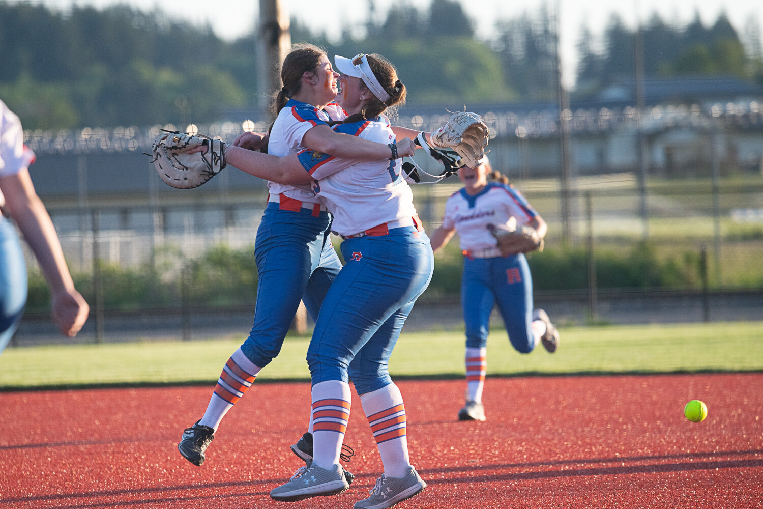 Elizabeth Peery hugs Maizy Whitlow after the final out of Ridgefield's 4-3 win over Tumwater in the semifinals of the 2A District 4 tournament on May 18 at Rec Park in Chehalis.