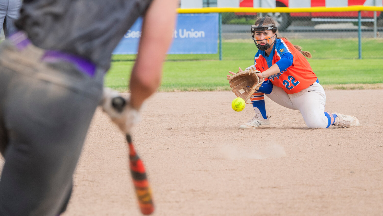 Ridgefield’s Madison Walker (22) stops a ground ball and makes an out during a state title game against North Kitsap at Carlon Park in Selah on Saturday, May 27.